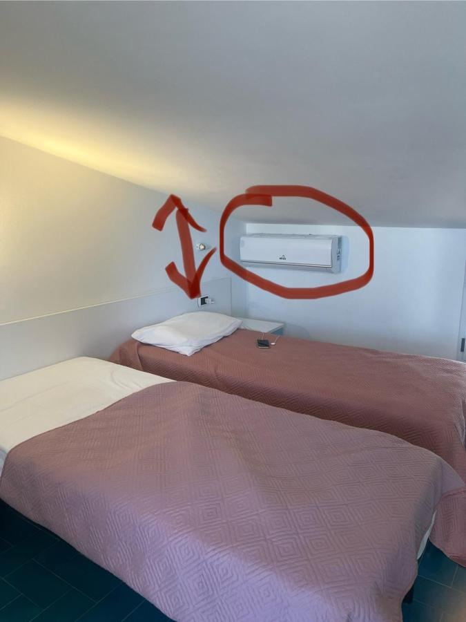 Letto o letti in una camera di Villa Kore, Capo Vaticano