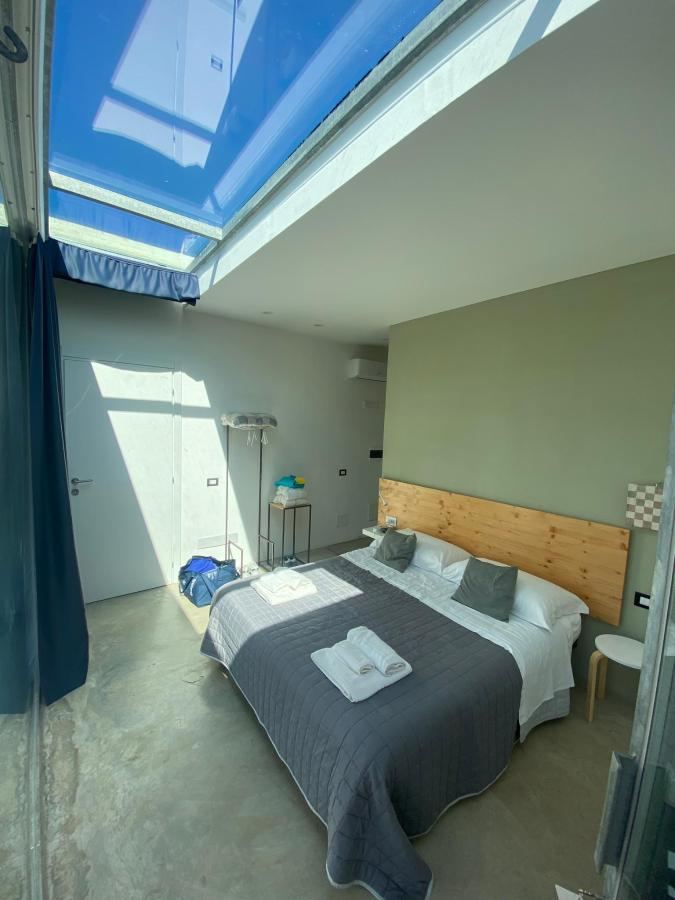 Letto o letti in una camera di Terecate Experimental Relais