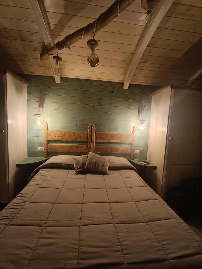 Letto o letti in una camera di Il Giardino dei Flintstones B&B