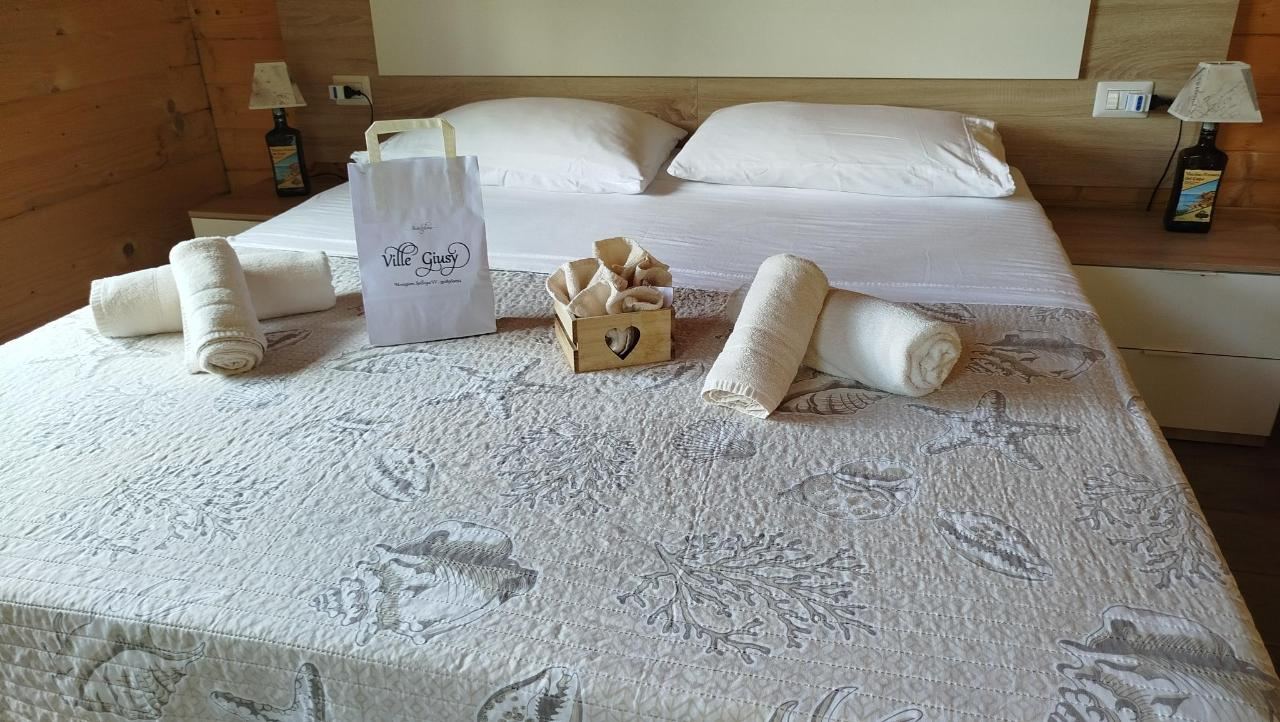 Letto o letti in una camera di Residence Il Tiglio